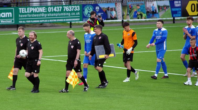 Match officials lead out both teams. Pictures by Gordon Thomas